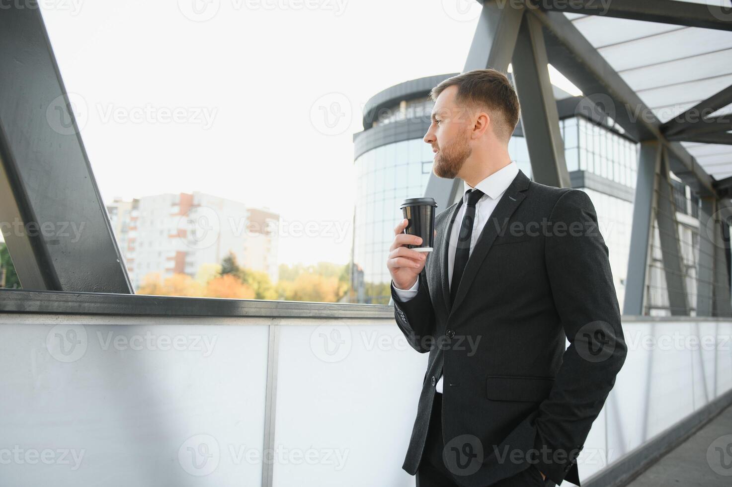 Takeaway coffee. Walk and enjoy fresh hot coffee. Waiting for someone in street. Man bearded hipster drink coffee paper cup. Businessman well groomed enjoy coffee break outdoors urban background photo