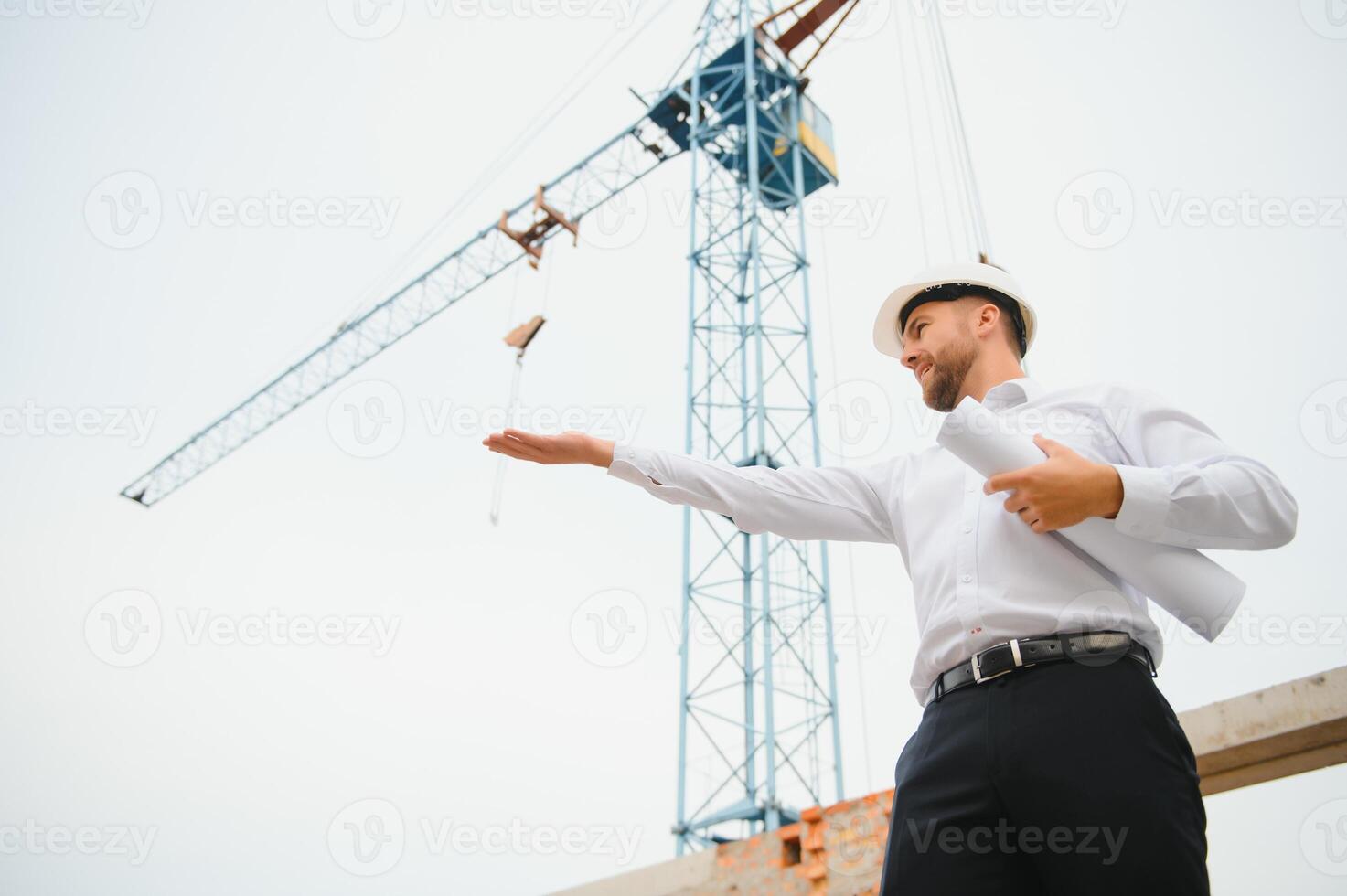 Construction concept of Engineer working at Construction Site with blue print. photo