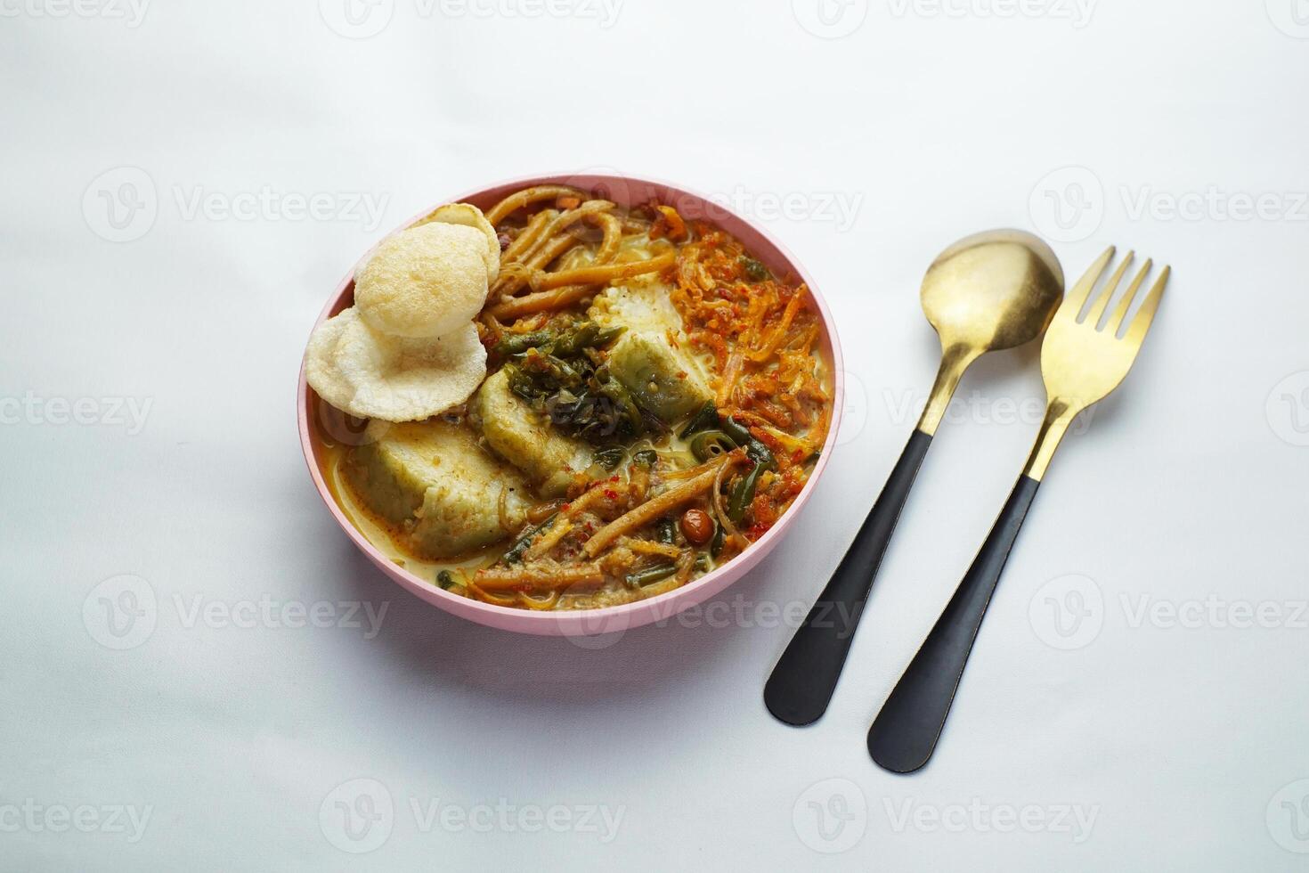 Lontong with curry soup accompanied by fried sweet potatoes chili sauce and noodles photo