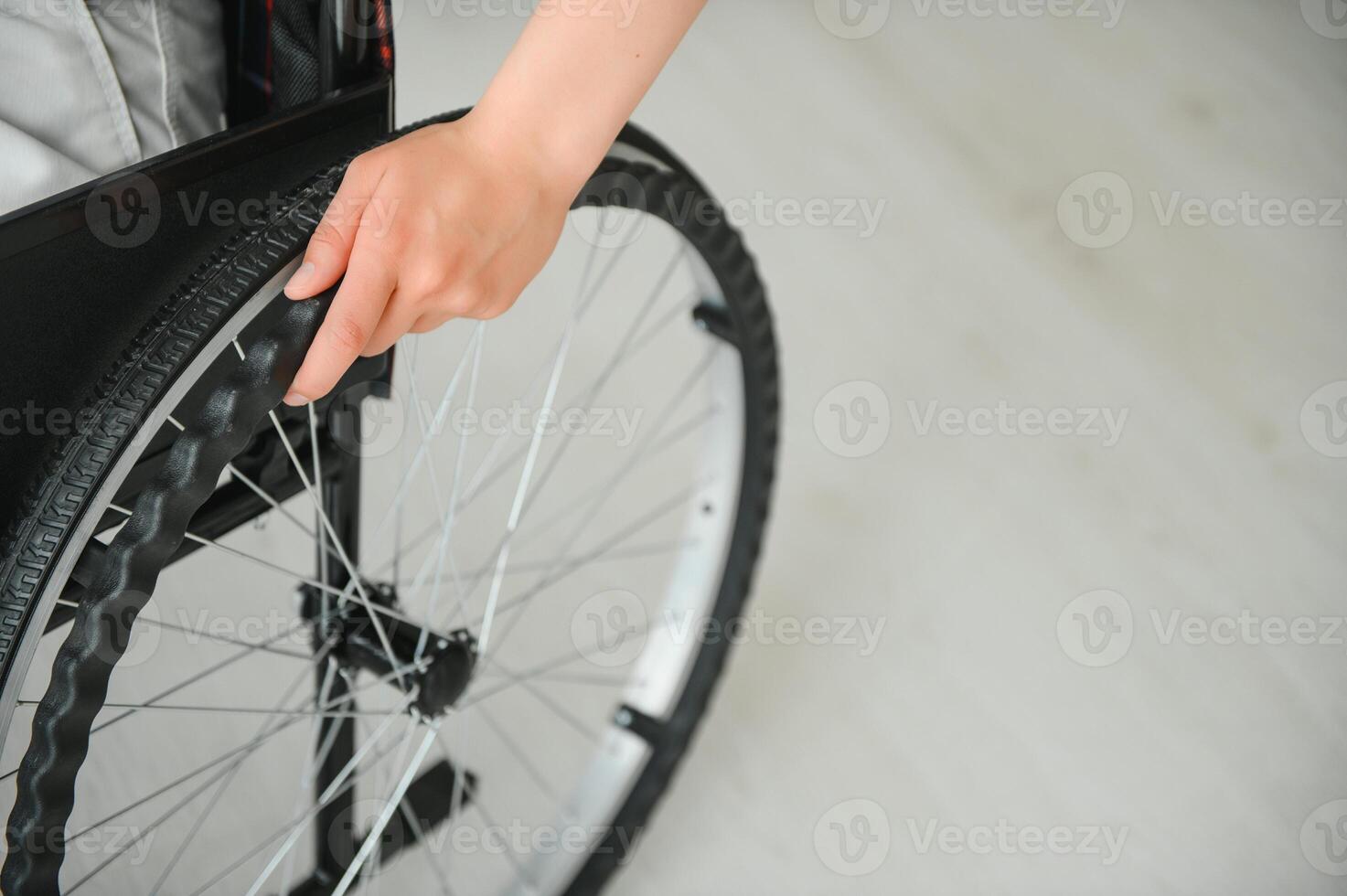 Young woman sitting in a wheelchair photo