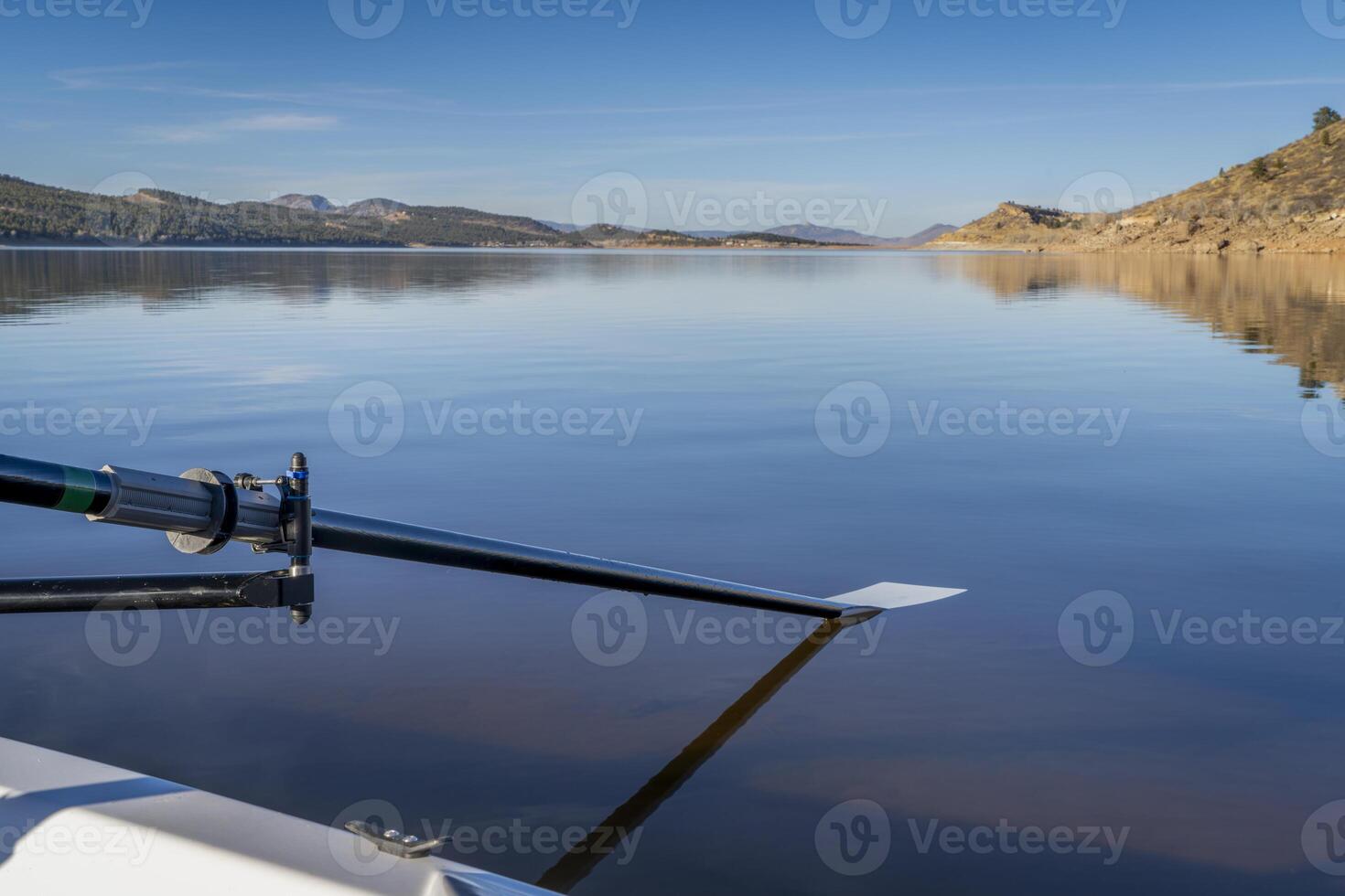 hatchet oar and a rowing shell on a shore of Carter Lake in northern Colorado in winter scenery photo