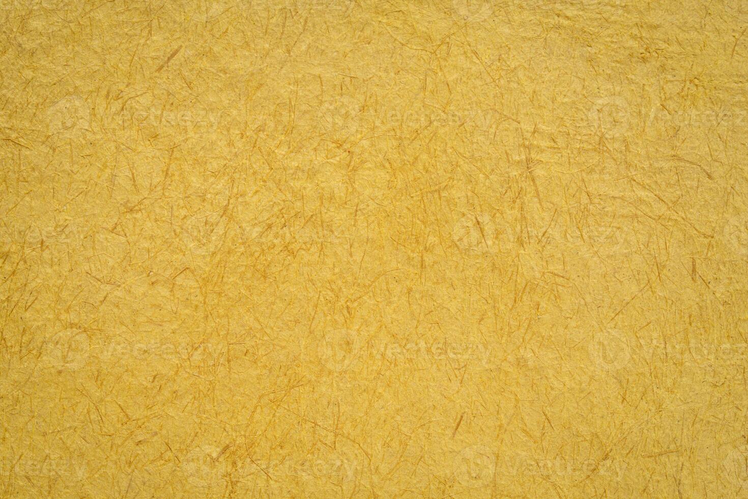 closeup background of yellow Huun Mayan handmade paper created in Mexico photo