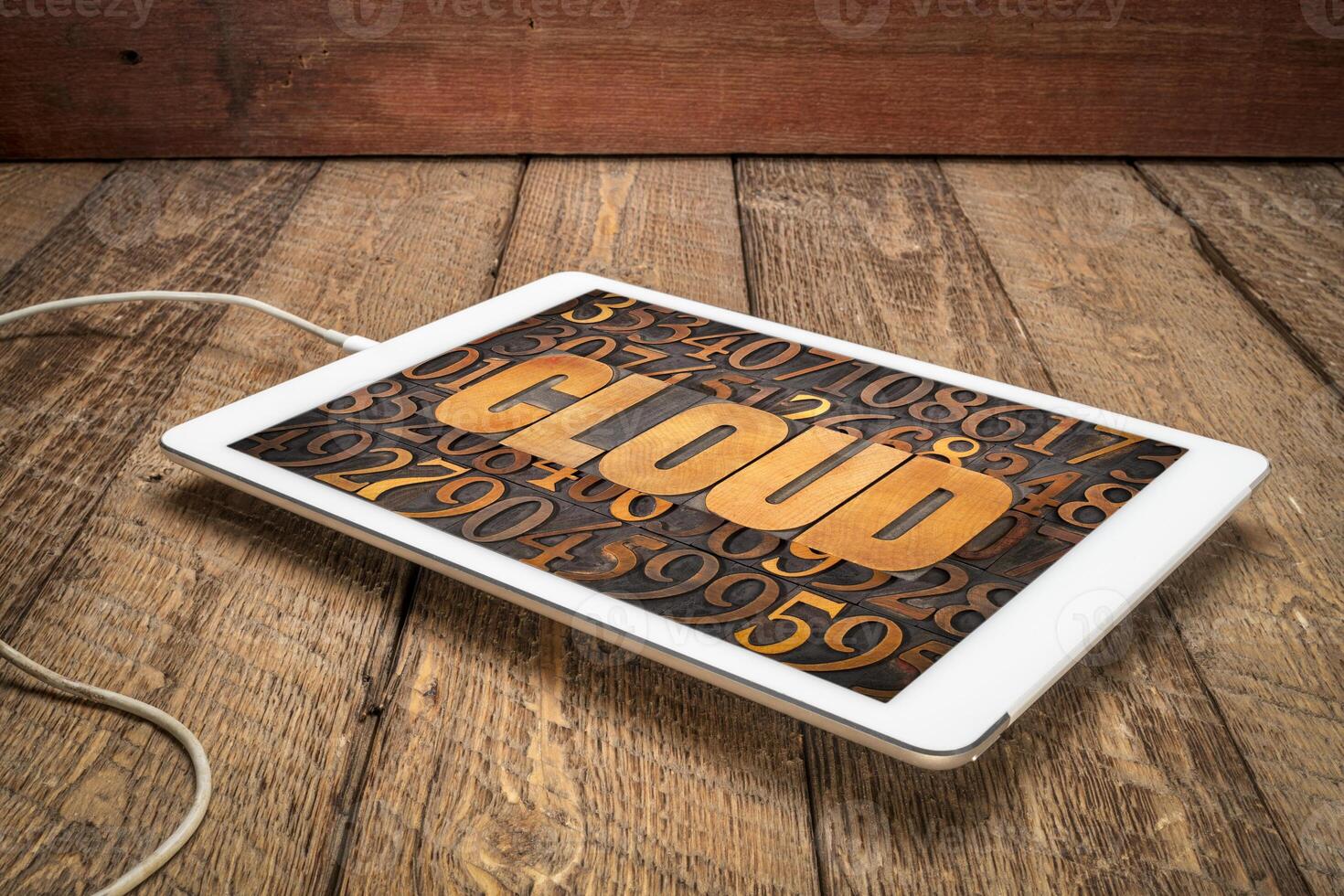 cloud computing concept - word in vintage letterpress wood type against numbers on a digital tablet photo