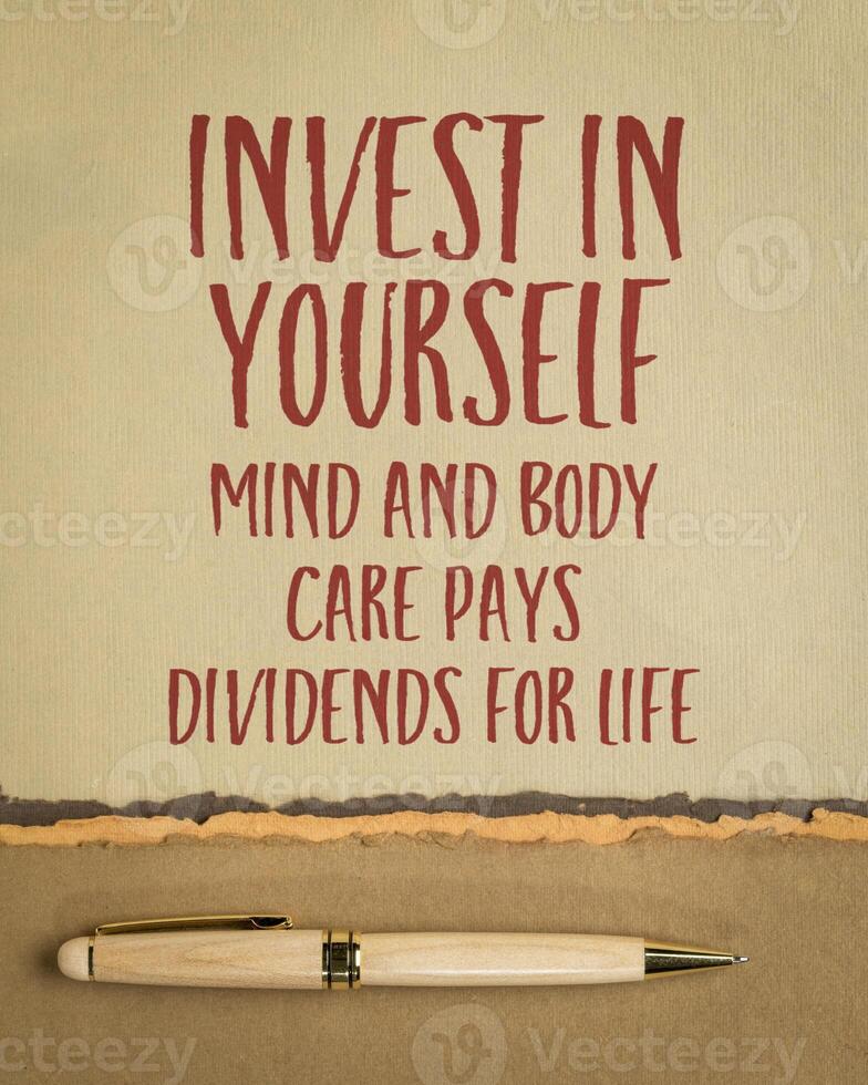 Invest in yourself. Mind and body care pays dividends for life. Inspirational advice or reminder on a art paper, self care concept. photo