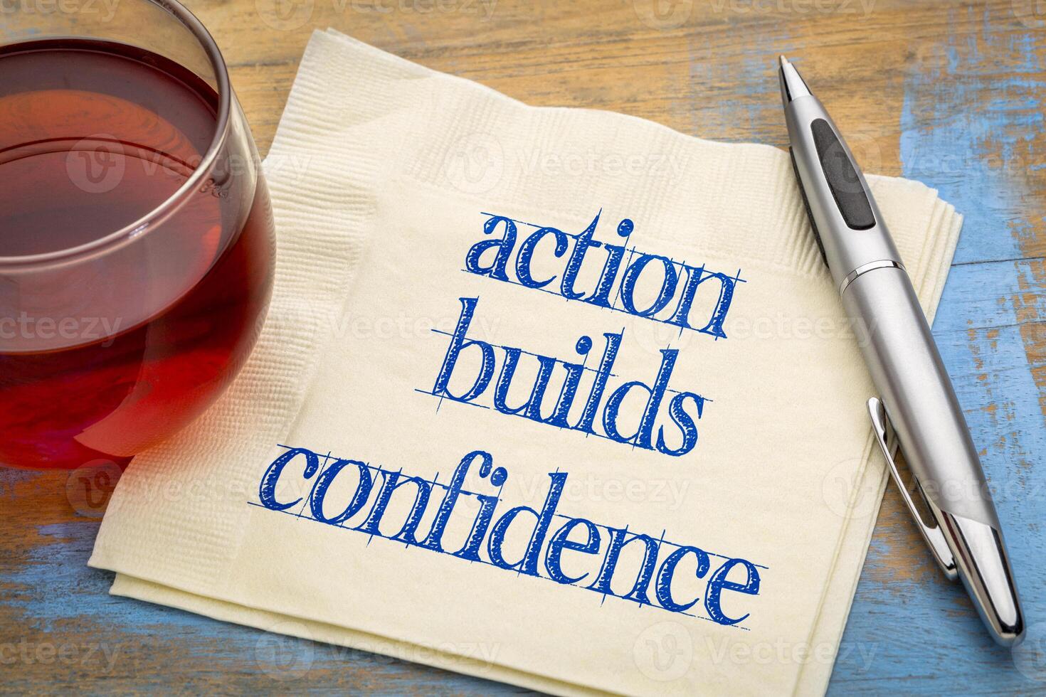 action builds confidence - inspirational note on anpkin with tea, personal development concept photo