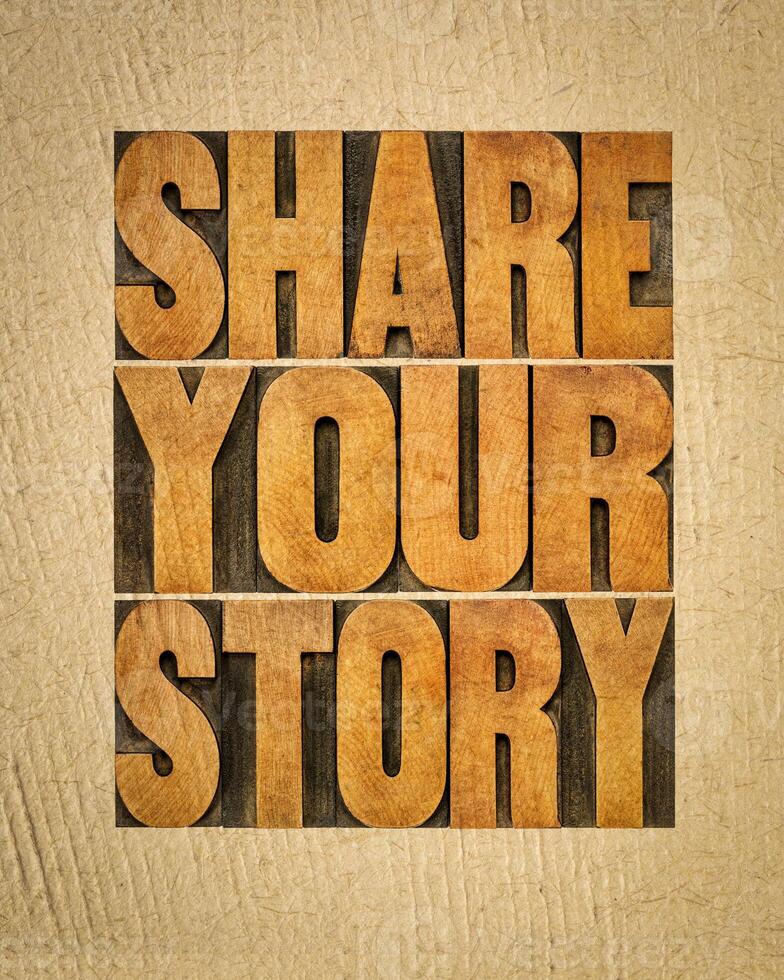 share your story word abstract  - inspirational text in vintage letterpress wood type on art paper, experience sharing concept photo