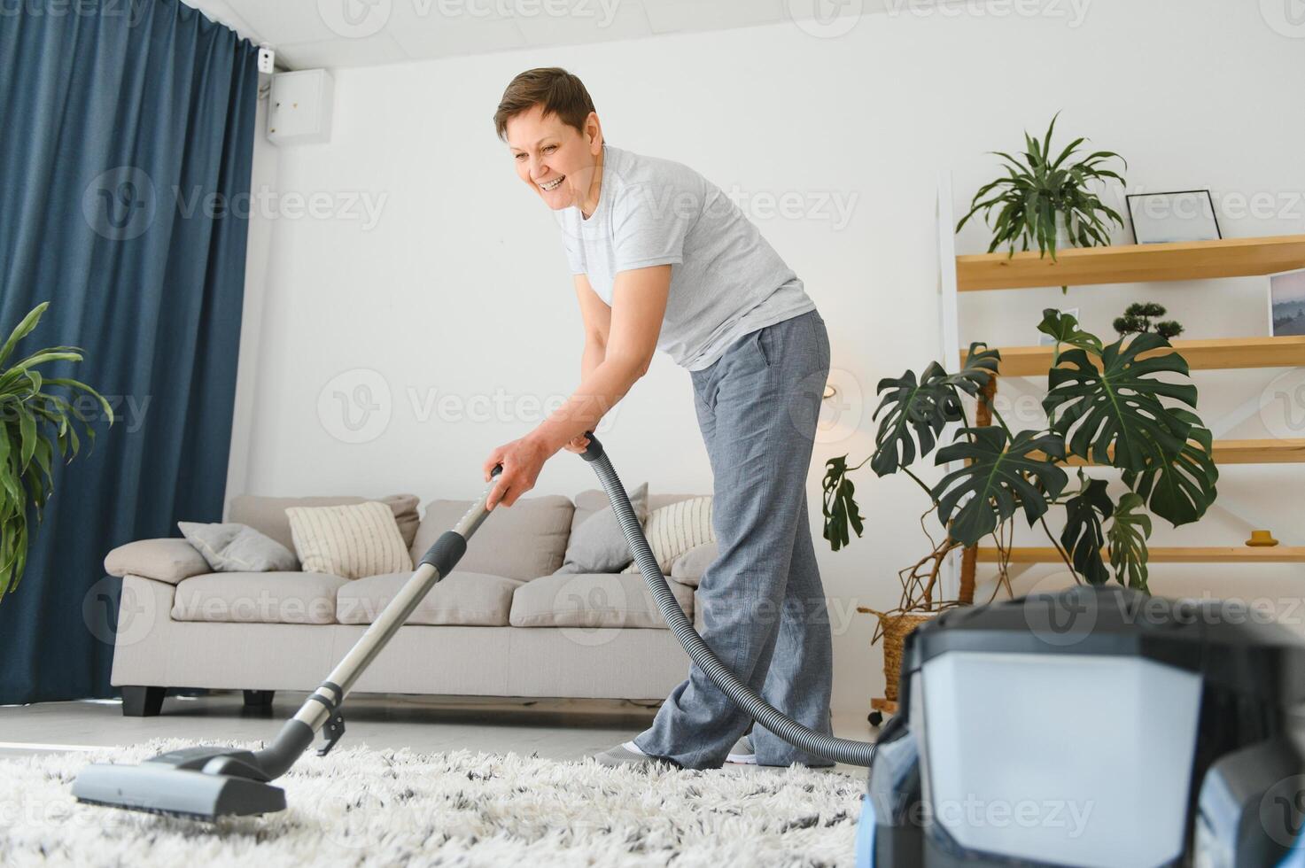 Woman with accumulator vacuum cleaner. photo