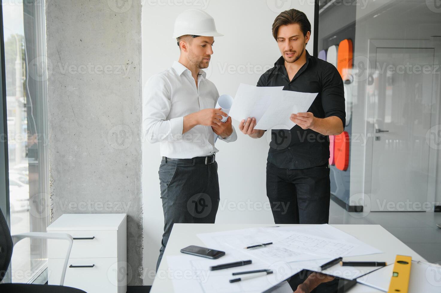 Engineer or architect teamwork working on construction project with building model and blueprint in office. Construction concept. photo