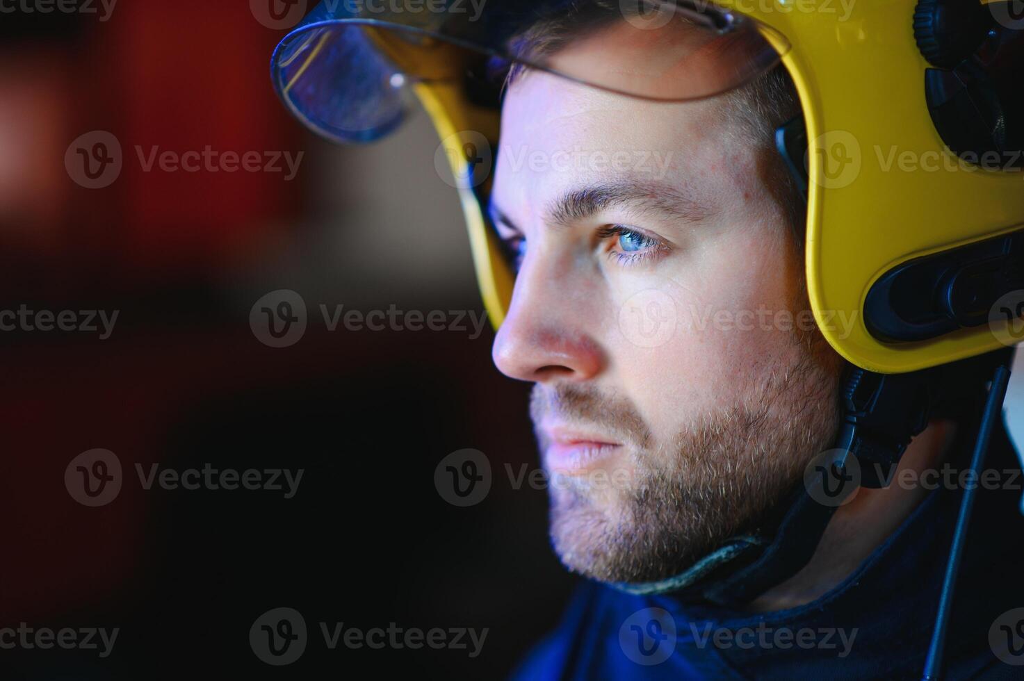 Photo of fireman with gas mask and helmet near fire engine