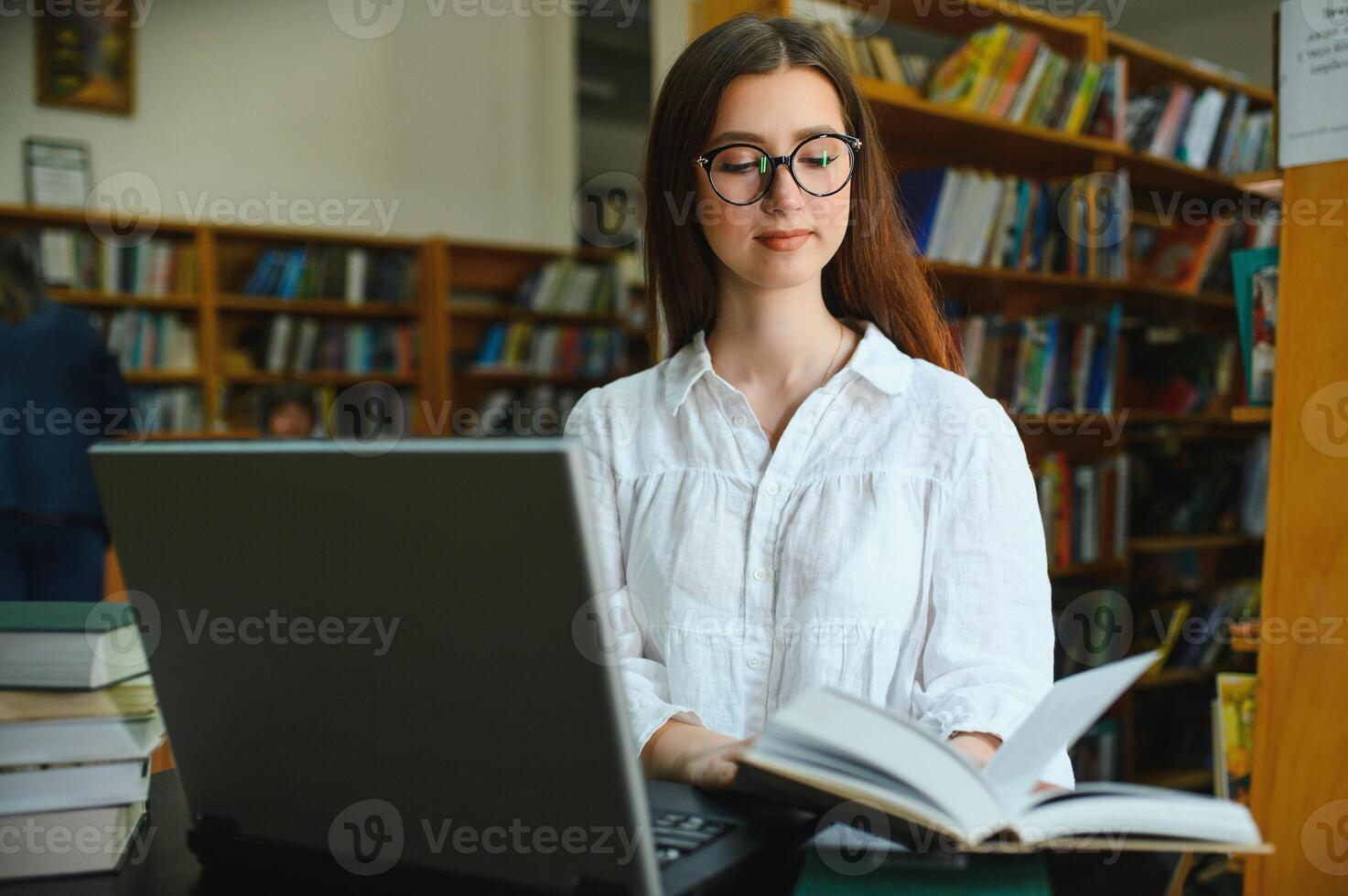 Portrait of a beautiful student in a library photo