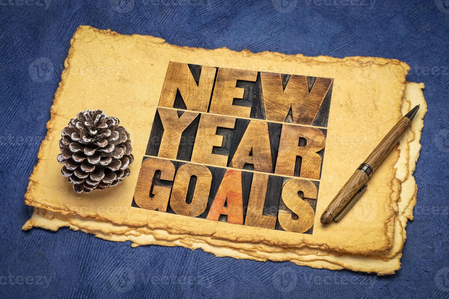 New Year goals - resolution and goal setting concept - word abstract in vintage letterpress wood type on retro art paper photo