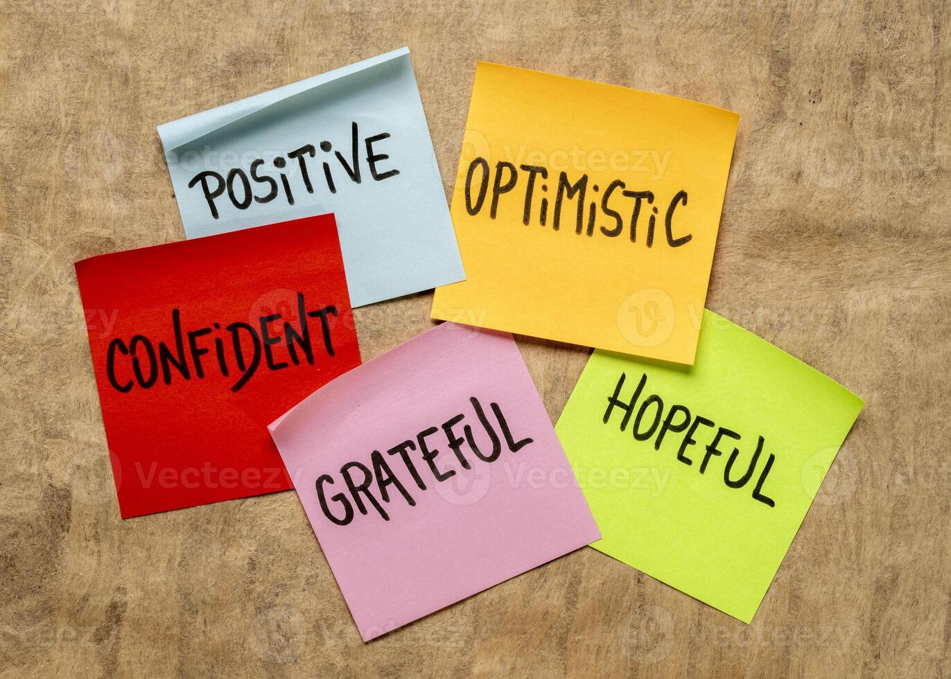 inspirational power words - optimistic, confident, hopeful, positive, grateful, - set of sticky reminder notes against bark art paper photo