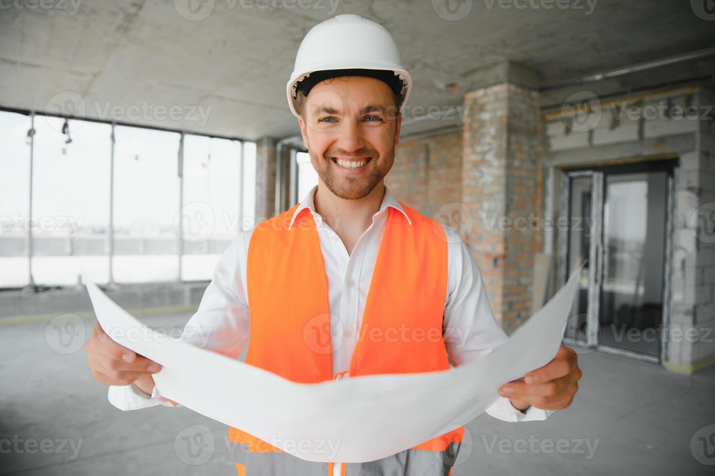 Portrait of man architect at building site. Confident construction manager wearing hardhat. Successful mature civil engineer at construction site with copy space. photo