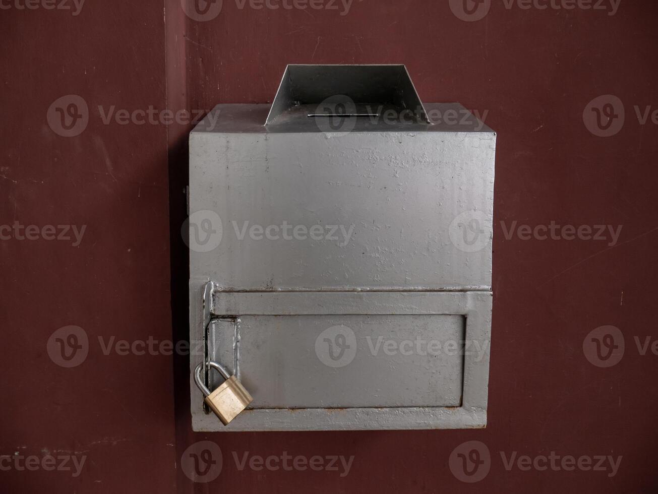 silver charity box in the mosque with a small lock photo