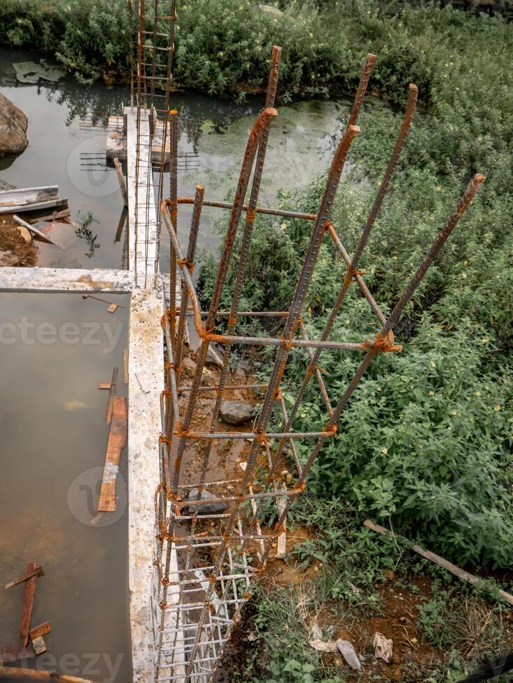 iron pillars that will be used for building pillars and no formwork wood has been installed photo