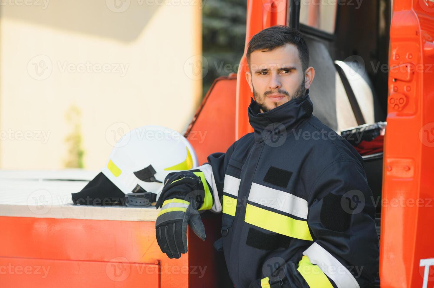Photo of fireman with gas mask and helmet near fire engine