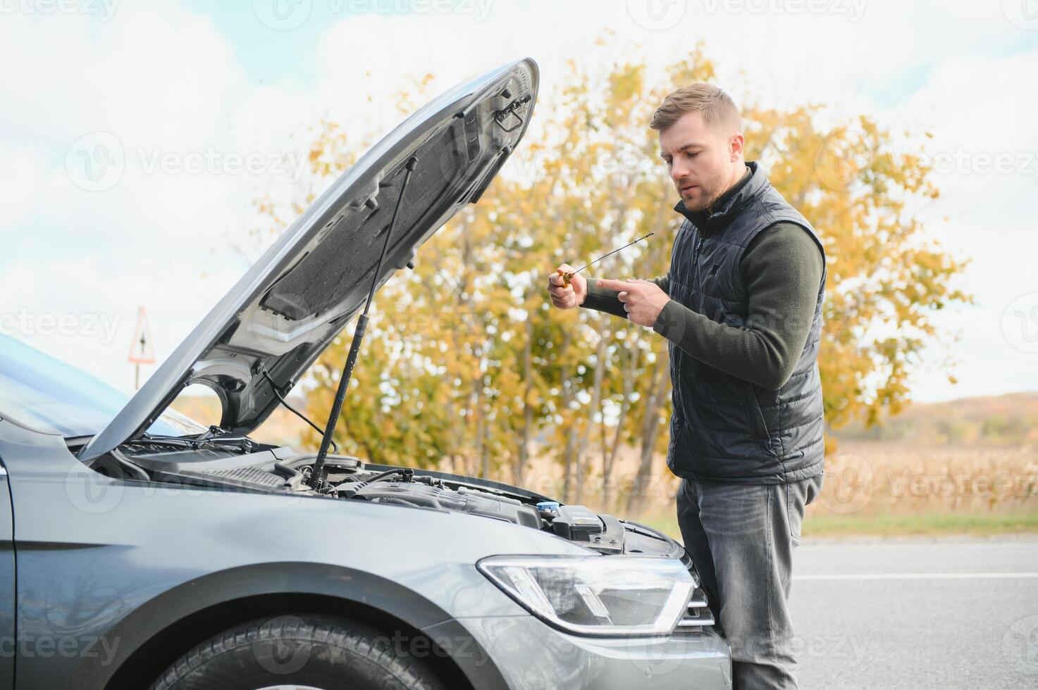 The car broke down, smokes from under the hood, the driver shocked photo