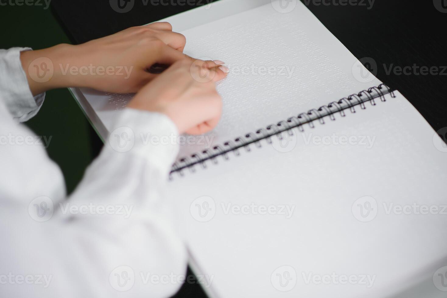 Blind woman read book written in Braille. Close up finger touch to braille Code photo