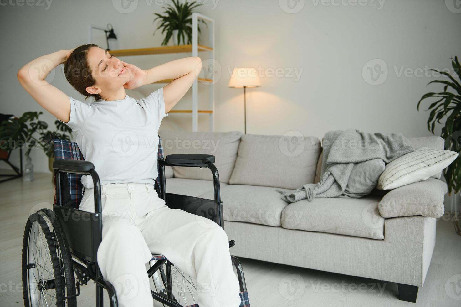 Brunette woman working out on wheelchair at home photo