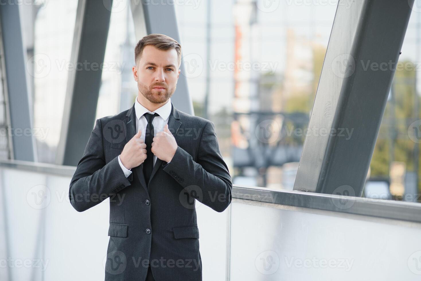 Handsome male model posing wearing a back suit. photo