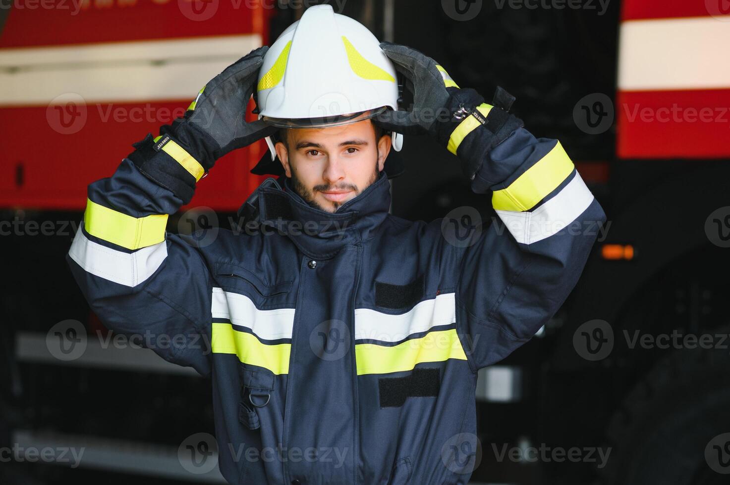 Photo of fireman with gas mask and helmet near fire engine