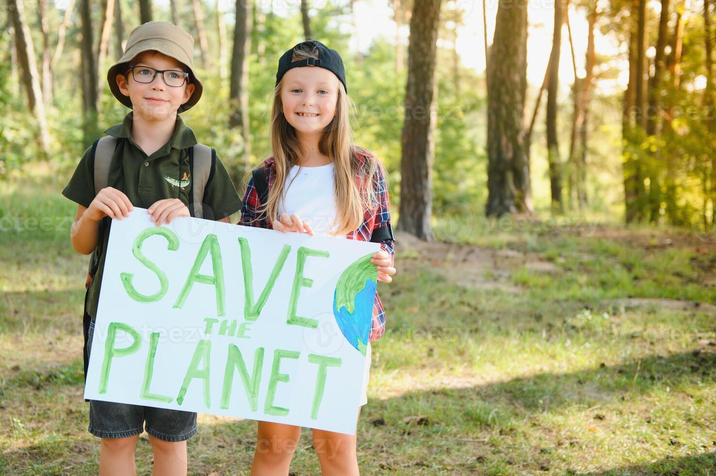 Children are holding a poster Save the planet. Earth Day. Let's save the planet from pollution. photo