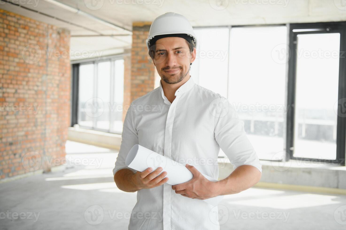 Close up engineers working on a building site holding a blueprints.Engineering and architecture concept photo