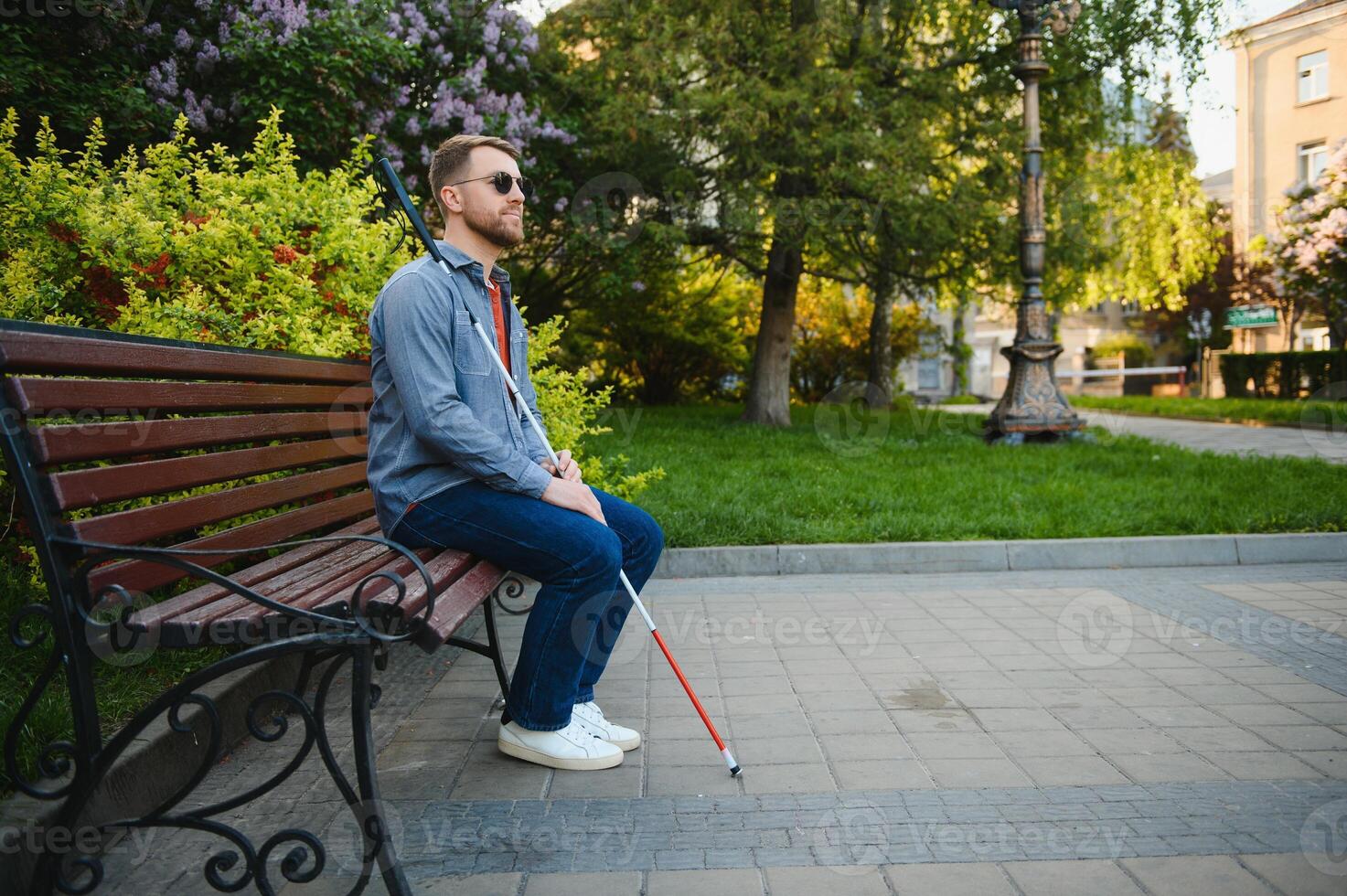 Blind man. People with disability, handicapped person and everyday life. Visually impaired man with walking stick. photo