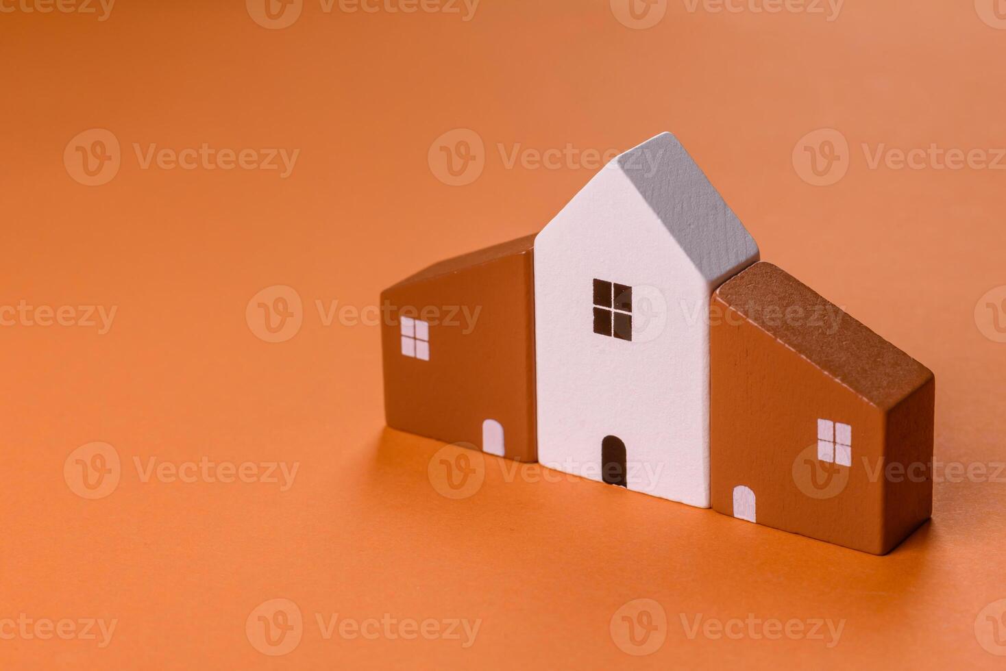 A small wooden house, money and keys as an idea for investing in your own home photo