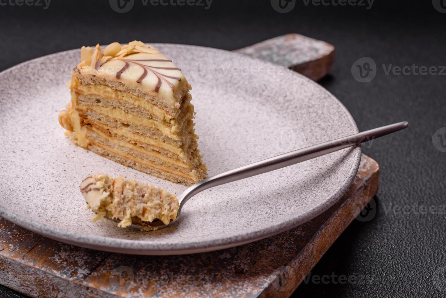 Piece of delicious sweet esterhazy cake with nuts and cream photo