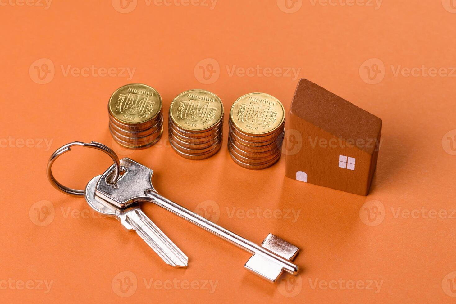 A small wooden house, money and keys as an idea for investing in your own home photo