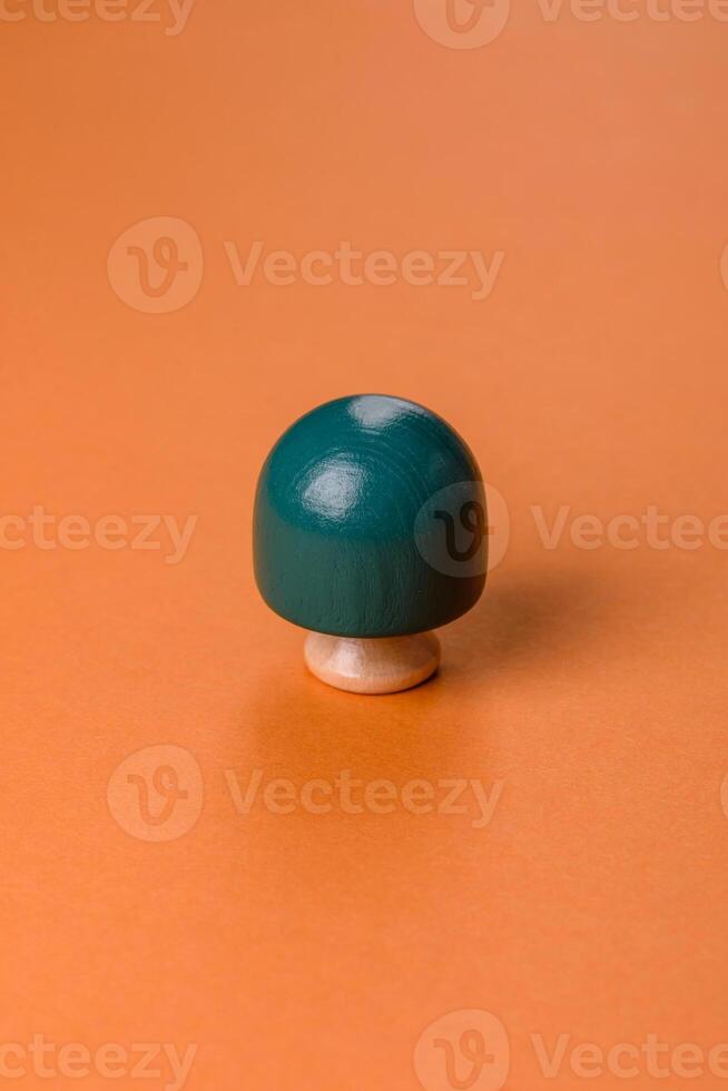 Wooden model of a tree with a green crown and trunk on a orange background photo