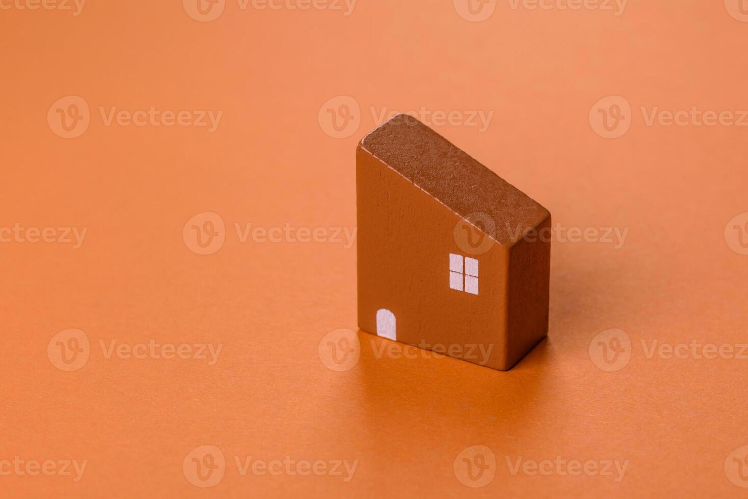 A small wooden house, money and keys as an idea for investing in your own home photo