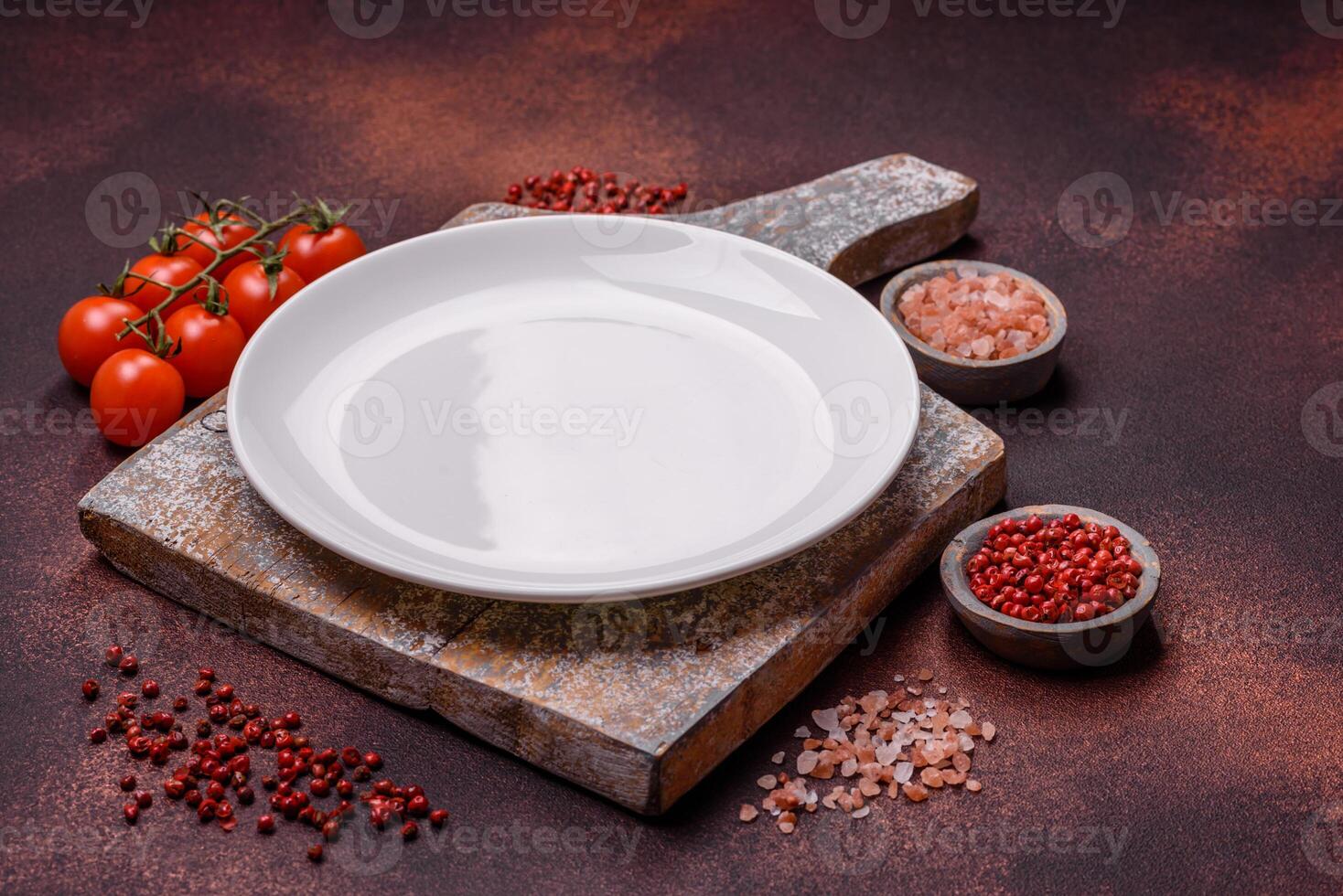 Empty ceramic round plate on dark textured concrete background photo