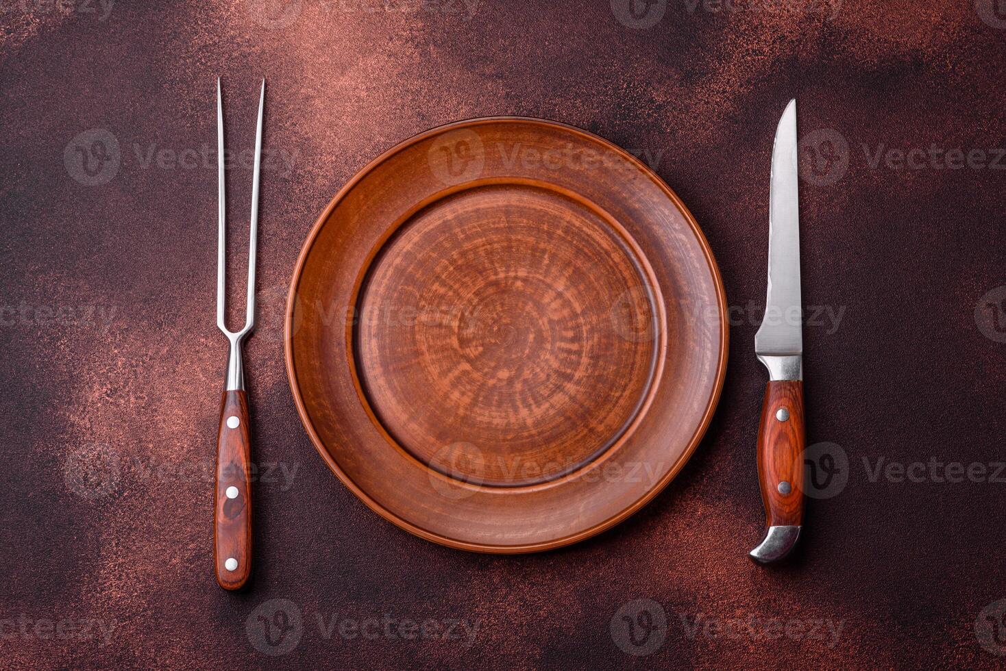 Empty ceramic round plate on dark textured concrete background photo