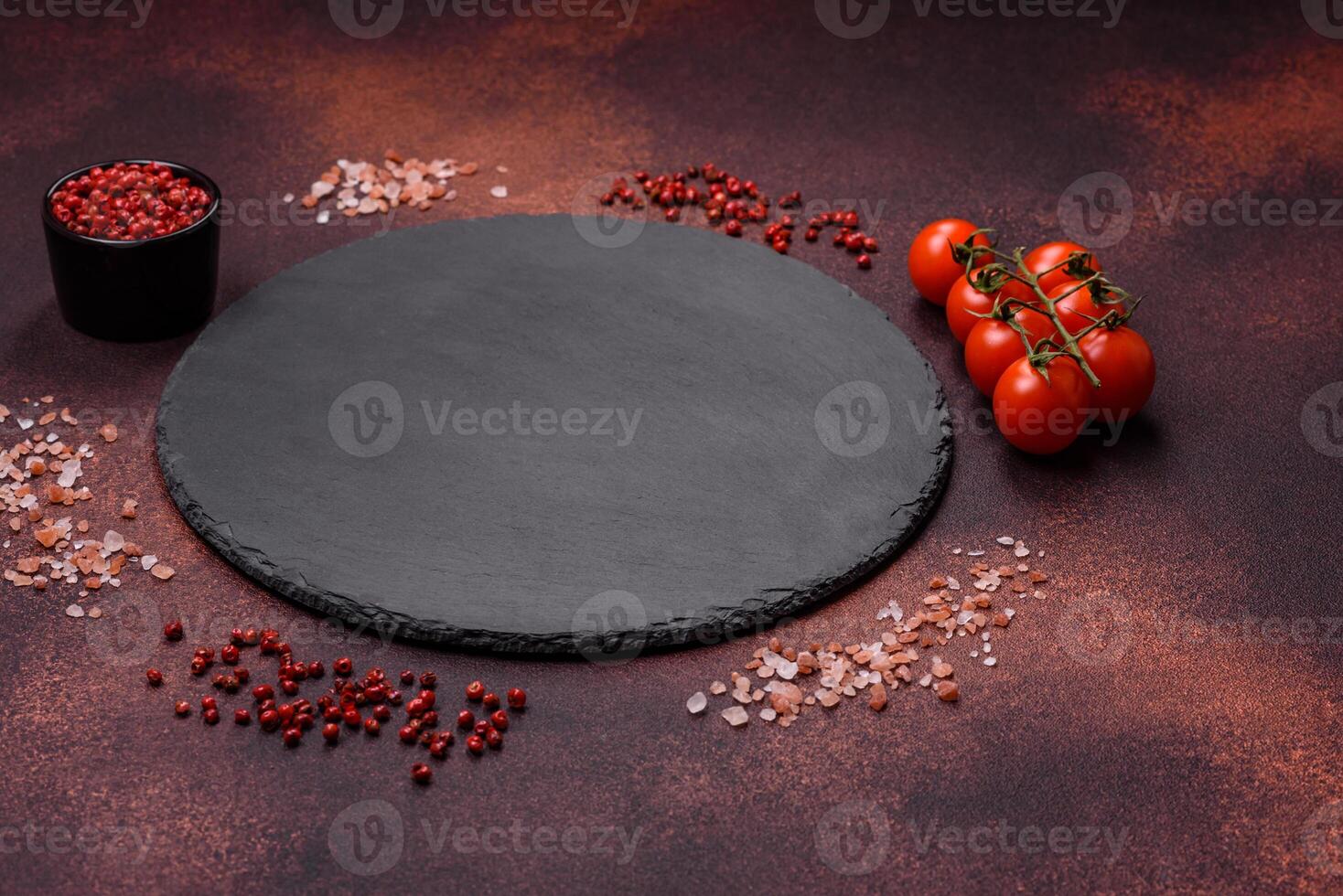 Empty ceramic round plate on dark textured concrete background photo