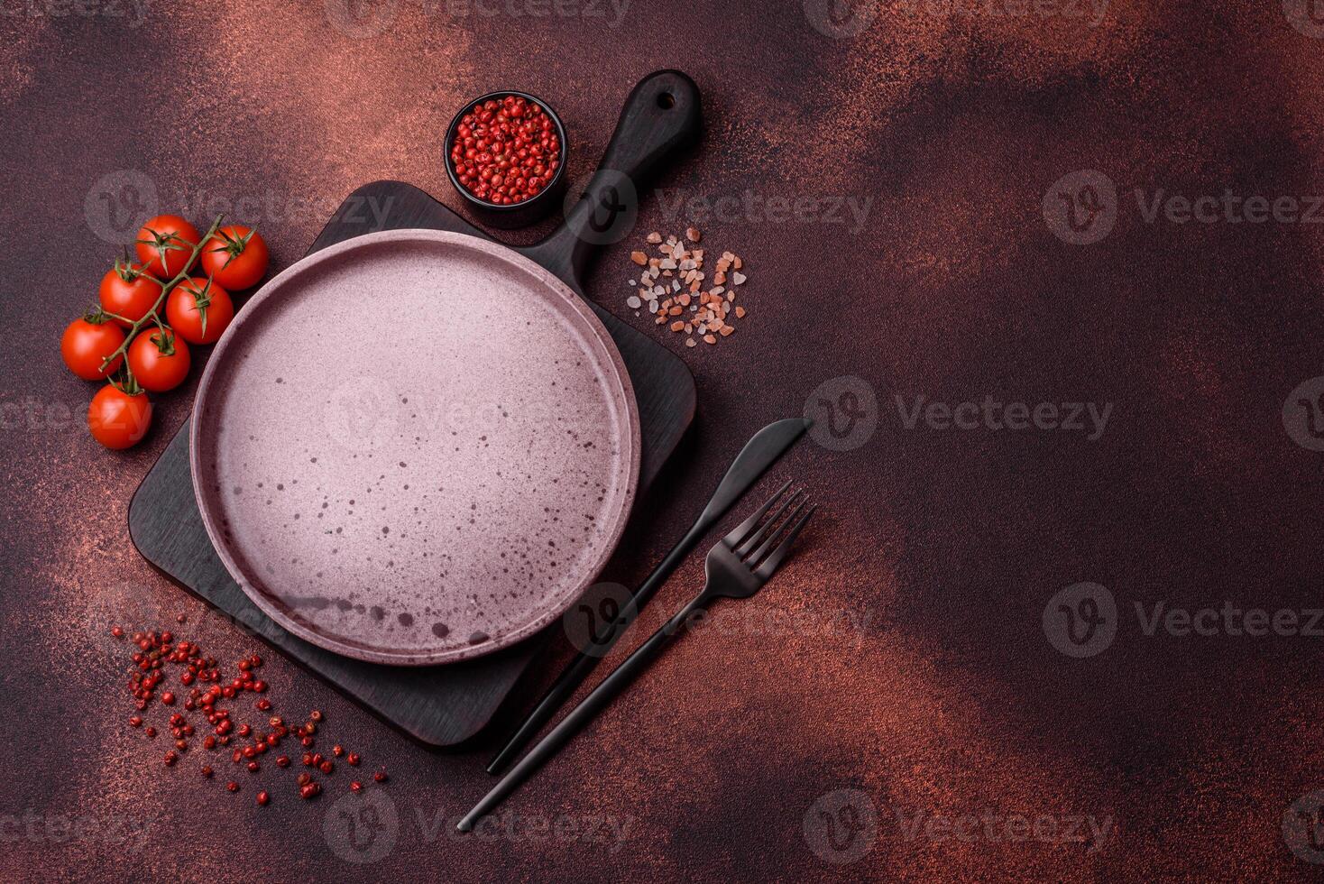 Empty ceramic round plate on dark textured concrete background photo