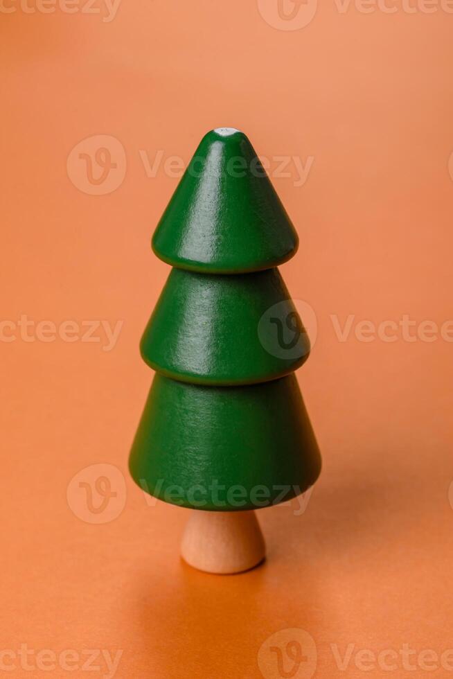 Wooden model of a tree with a green crown and trunk on a orange background photo