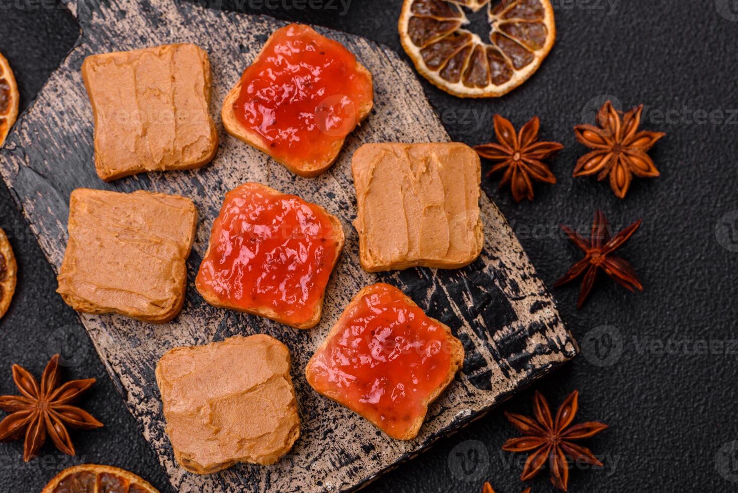 Delicious nutritious sandwiches with peanut butter, strawberry jam photo