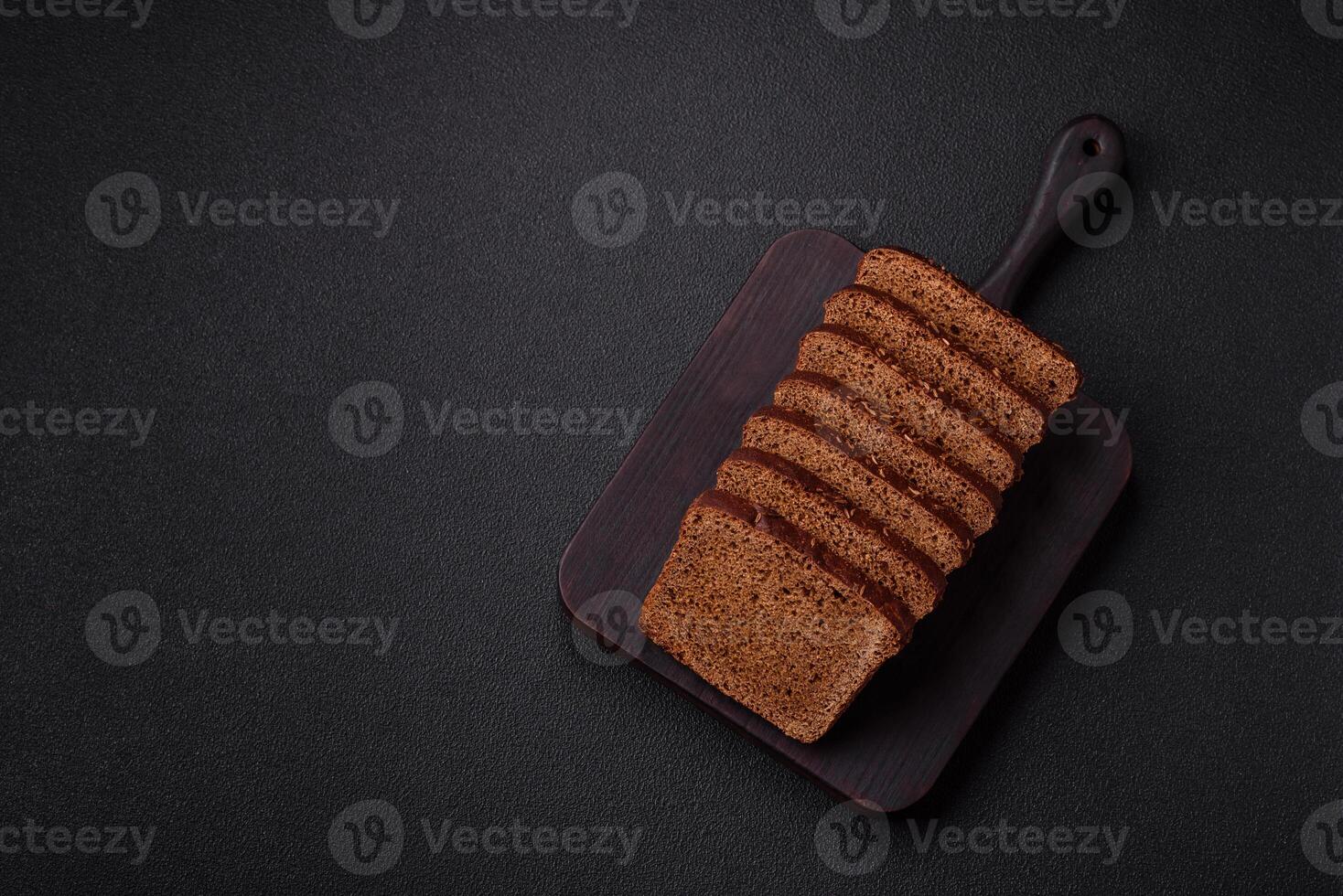 Delicious brown bread with seeds and grains cut into slices photo