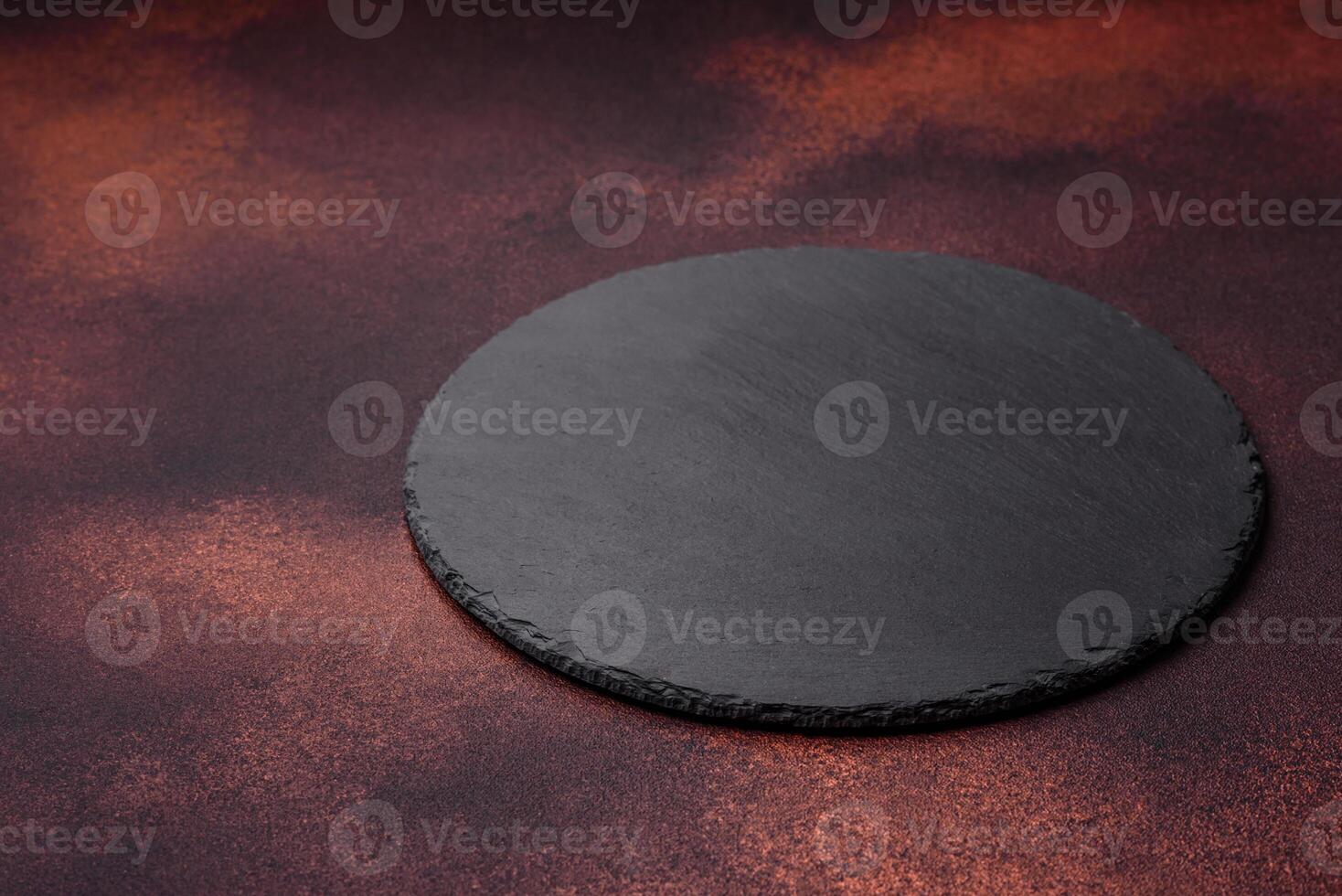 Empty ceramic round plate on dark textured concrete background photo