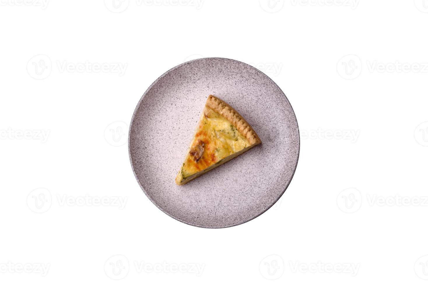 Delicious crispy quiche cut into slices with cheese, broccoli, tomatoes photo