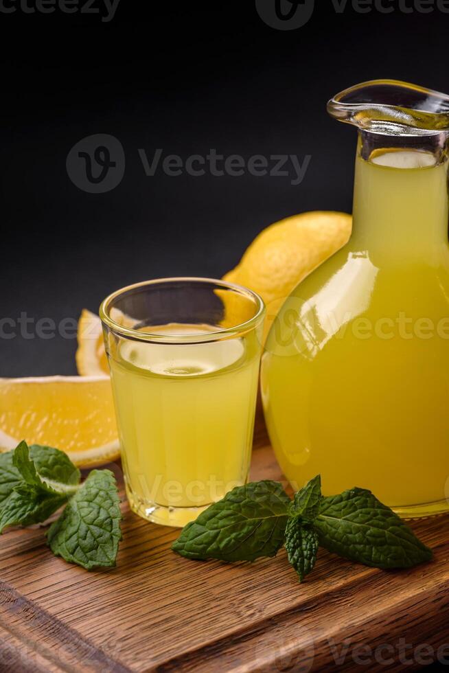 Alcoholic drink yellow limoncello in a small glass photo