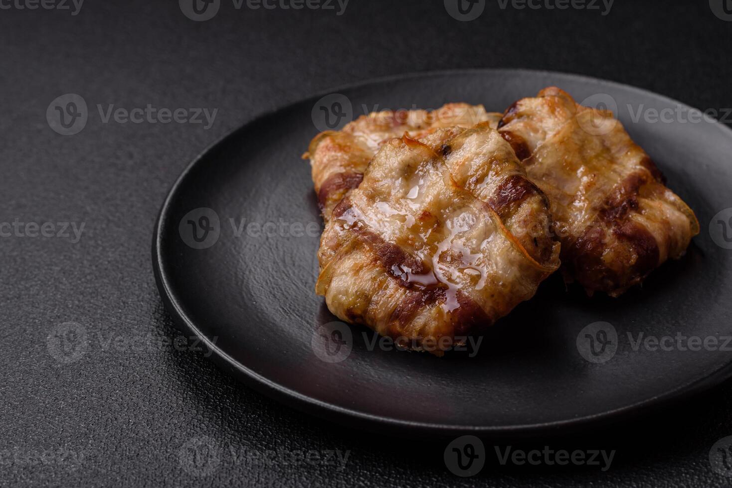 Round minced chicken or pork cutlet wrapped in bacon with salt, spices and herbs photo