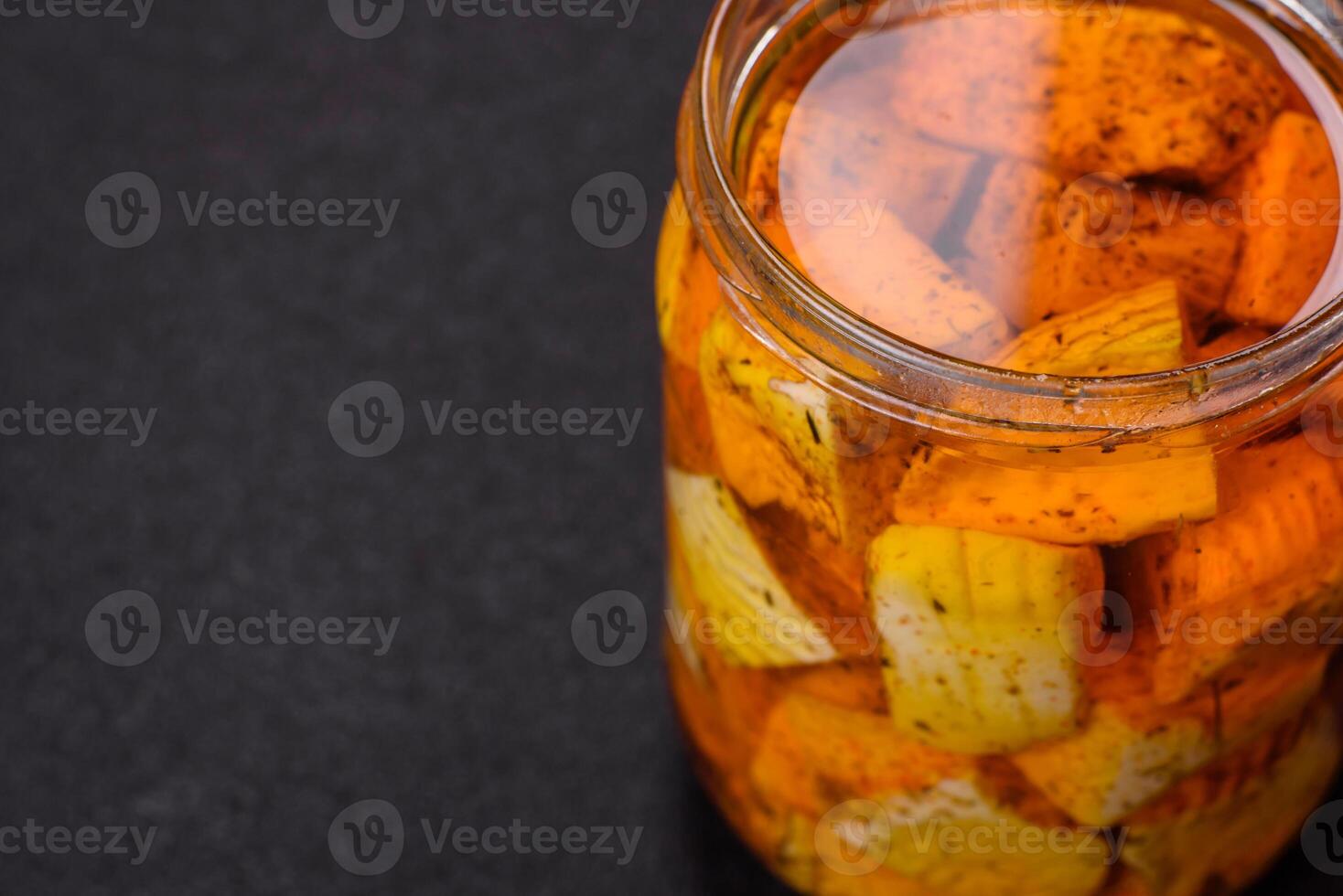 Delicious soft white feta cheese with salt, spices and herbs on a dark concrete background photo