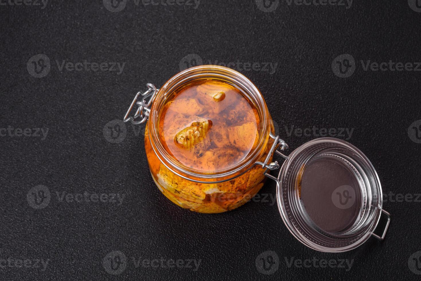 Delicious soft white feta cheese with salt, spices and herbs on a dark concrete background photo