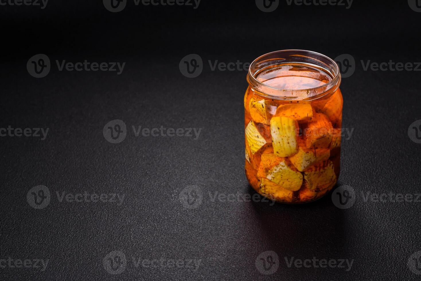 Delicious soft white feta cheese with salt, spices and herbs on a dark concrete background photo