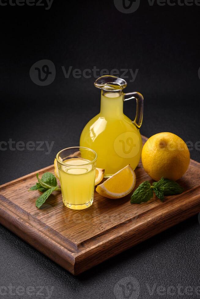 Alcoholic drink yellow limoncello in a small glass photo