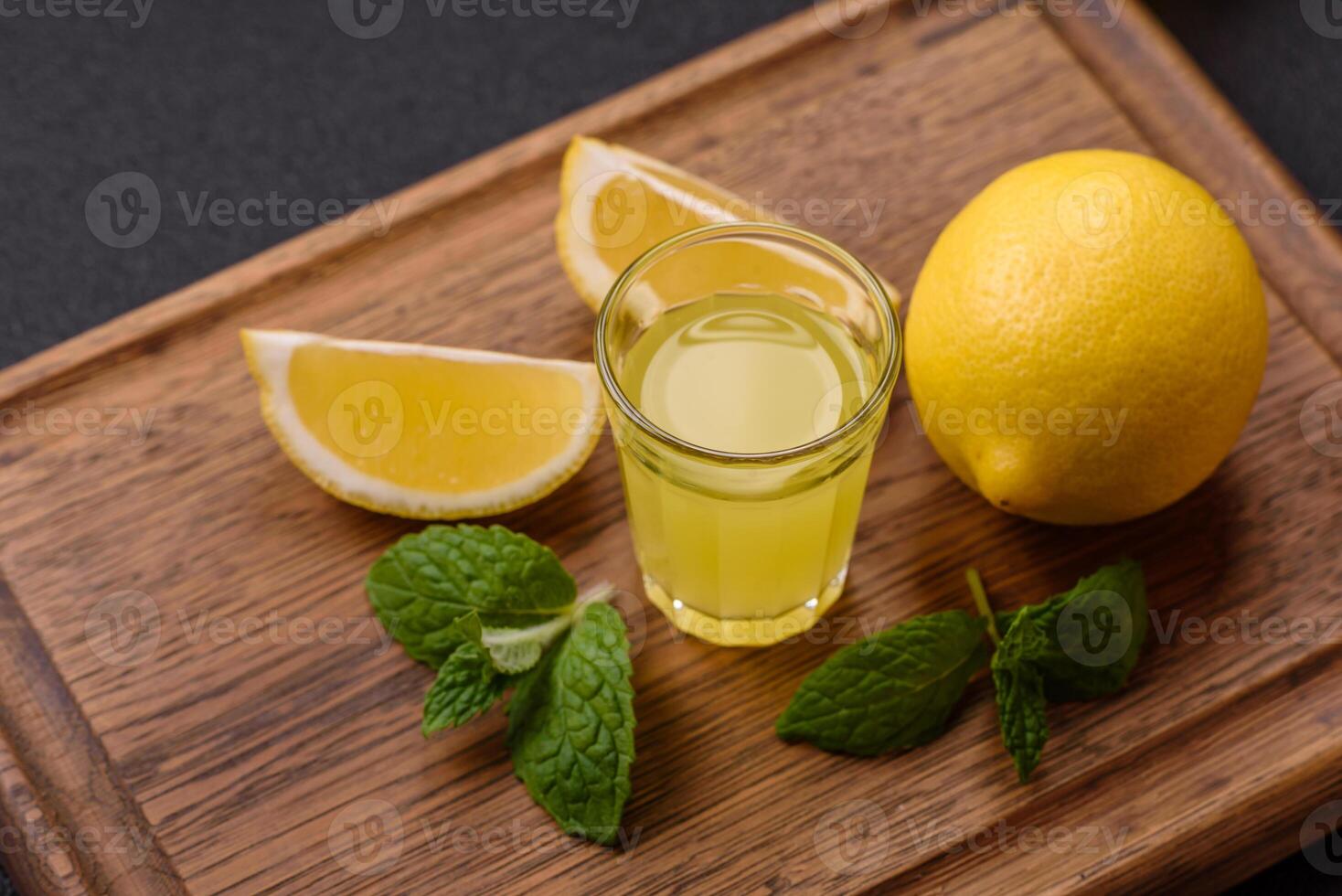 Alcoholic drink yellow limoncello in a small glass photo