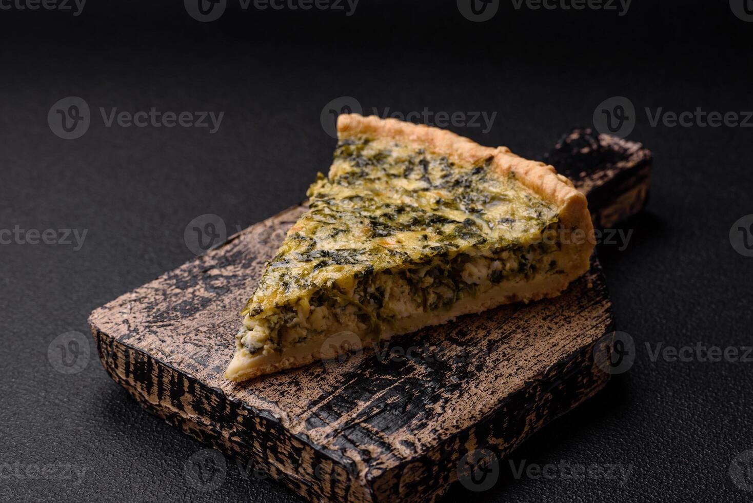Delicious crispy quiche cut into slices with cheese, broccoli, tomatoes photo